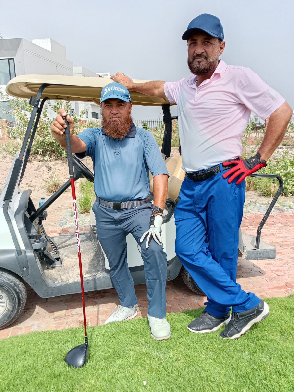 Golfers beside a cart at the academy